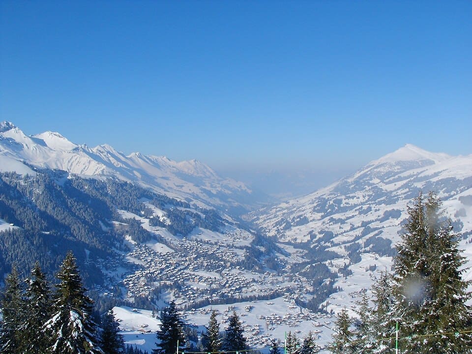 Adelboden village in winter, surrounded by the snow-covered peaks of the Bernese Oberland.