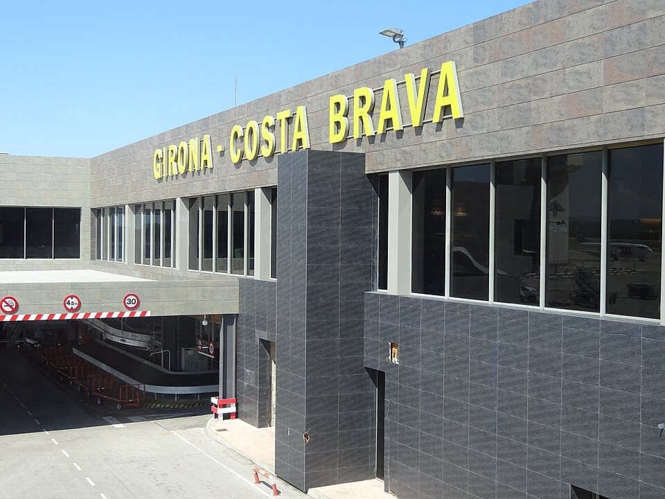 Wide exterior view of Girona-Costa Brava Airport terminal and runway