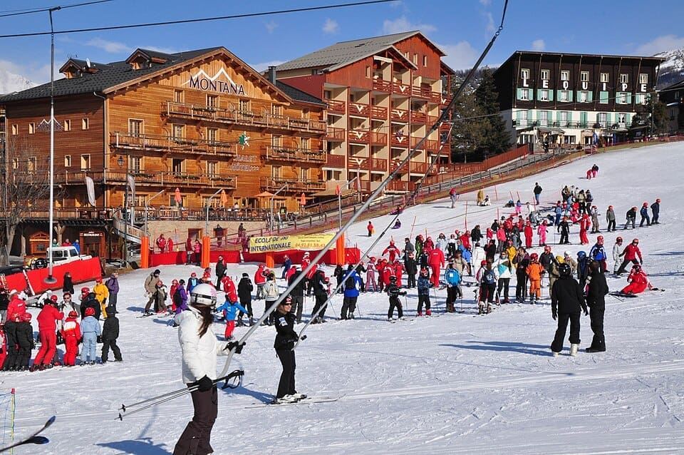 View of Le Sauze Super Sauze ski resort with snowy slopes under a blue sky