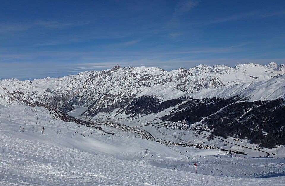 Snow-covered Livigno village and surrounding mountains in winter