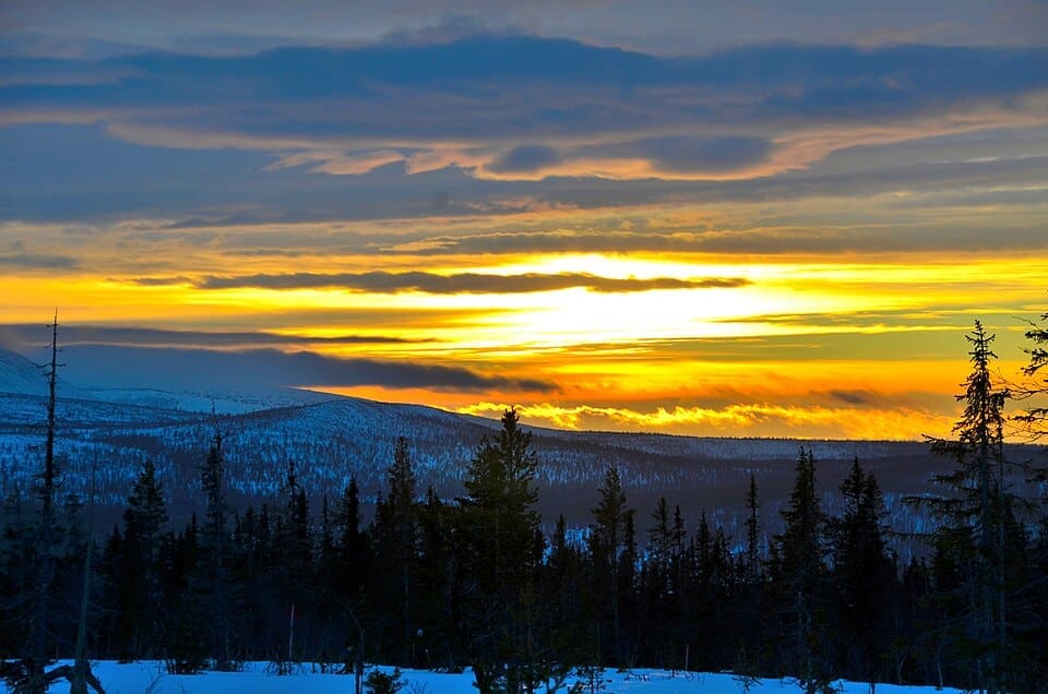 A cold sunset over the snowy peaks and village of Lofsdalen, Sweden