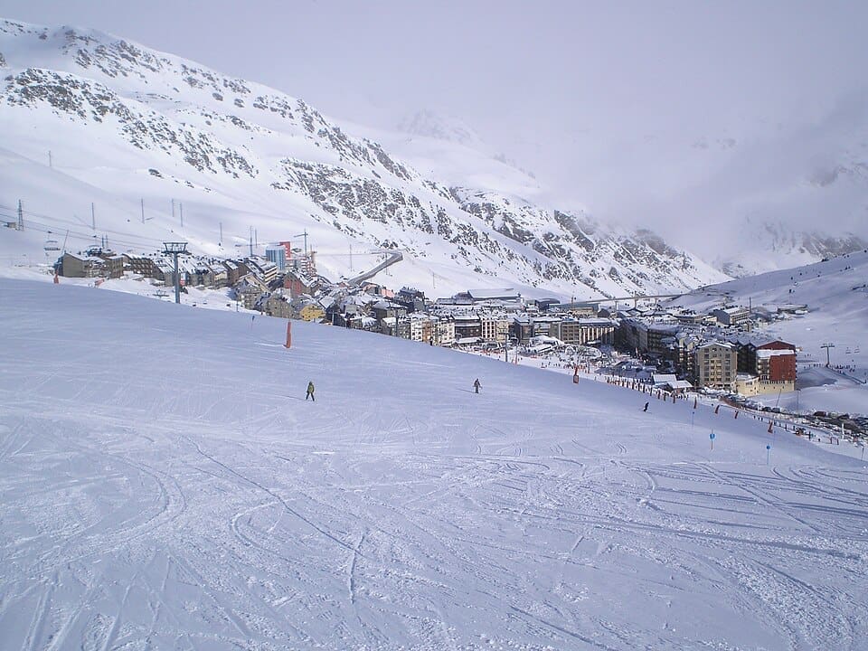 Snow-covered slopes and village of Pas de la Casa ski resort in winter