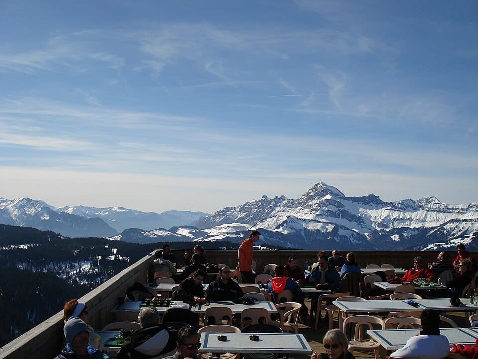 Winter view of the snowy slopes and lifts at Praz-sur-Arly ski resort