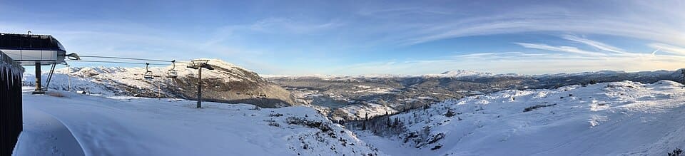 Panoramic view of Voss Resort at sunset with snow-covered slopes and Hangurstoppen summit